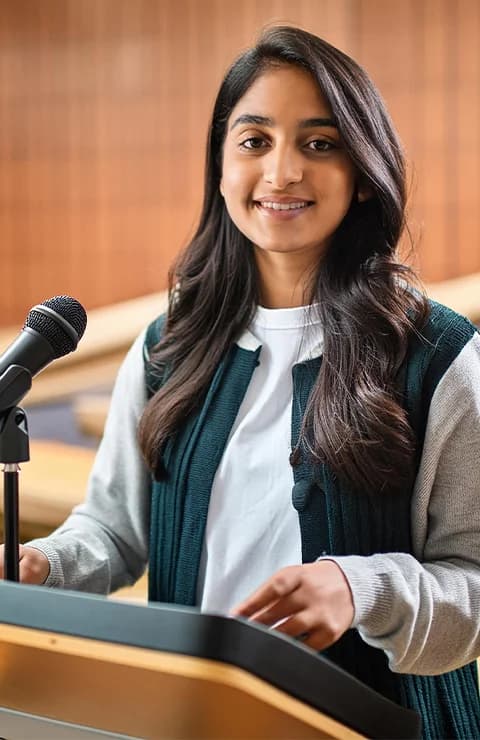 Student speaking at a podium